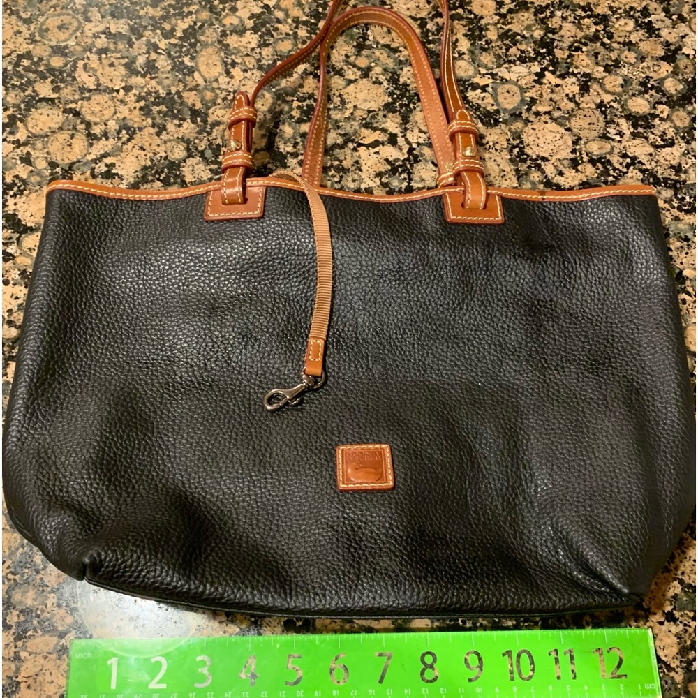 Dooney & Bourke black leather tote with brown leather straps.
